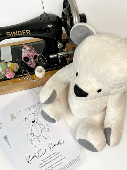 Arial view of Bertie Memory Bear, with vintage singer sewing machine and a printed copy of the pattern